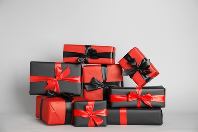 Many gift boxes on light grey background. Black Friday