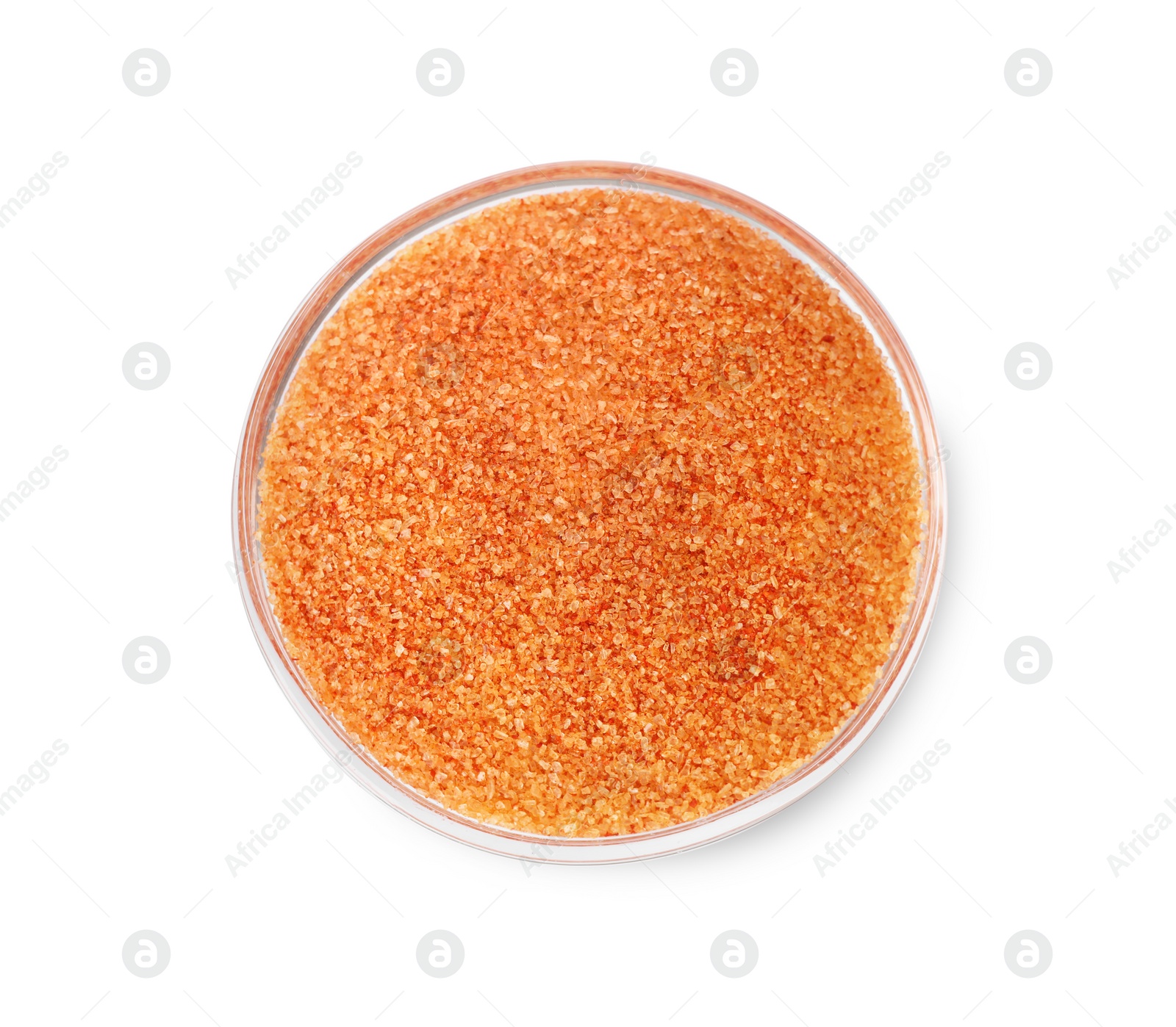 Photo of Orange salt in glass bowl isolated on white, top view