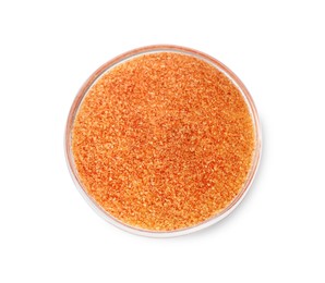 Orange salt in glass bowl isolated on white, top view