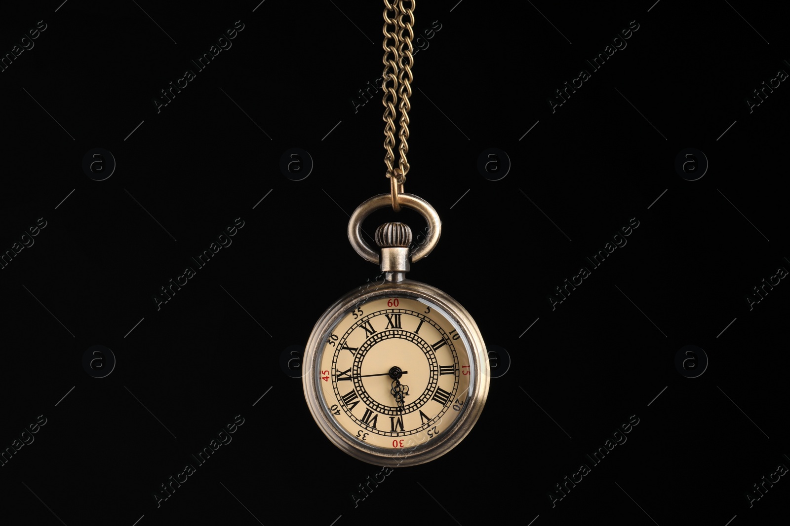 Photo of Beautiful vintage pocket watch with chain on black background. Hypnosis session