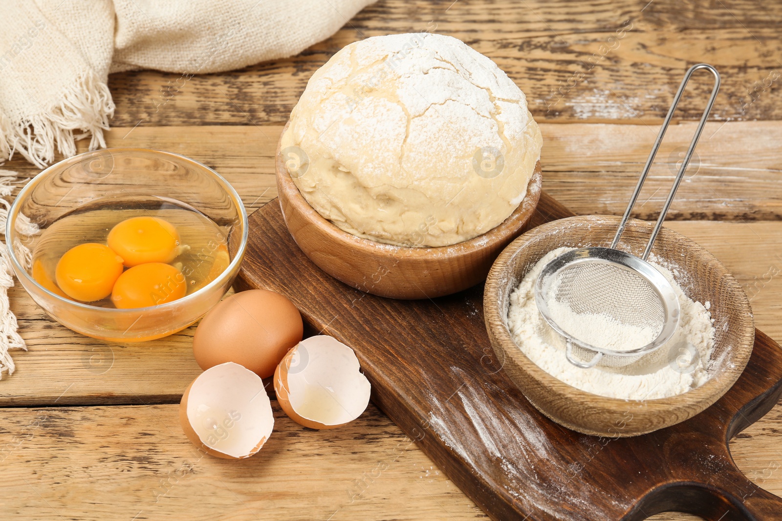 Photo of Raw eggs and other ingredients on wooden table. Baking pie