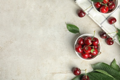 Flat lay composition with ripe sweet cherries on light table. Space for text