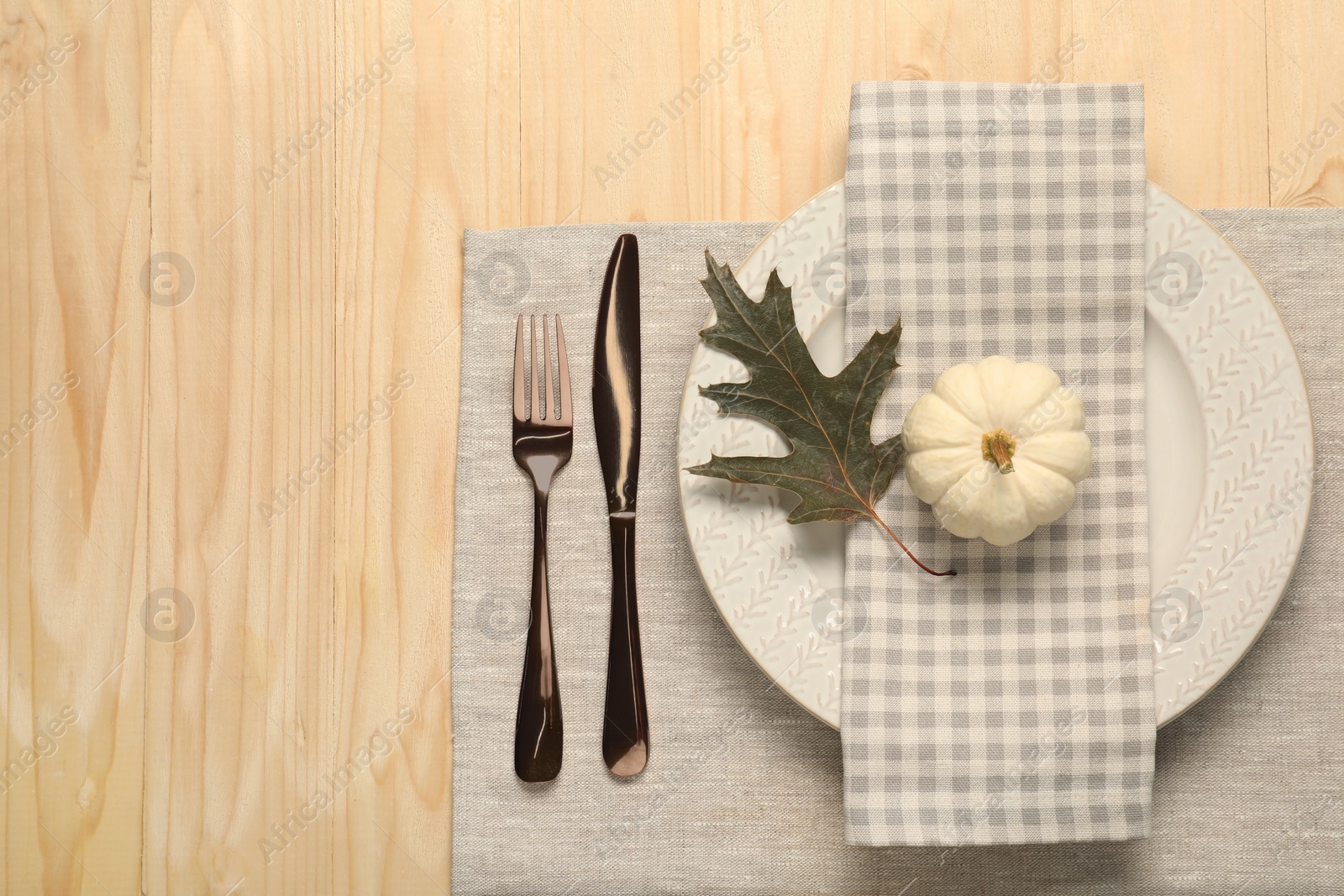 Photo of Autumn table setting, napkin and pumpkin, flat lay. Space for text