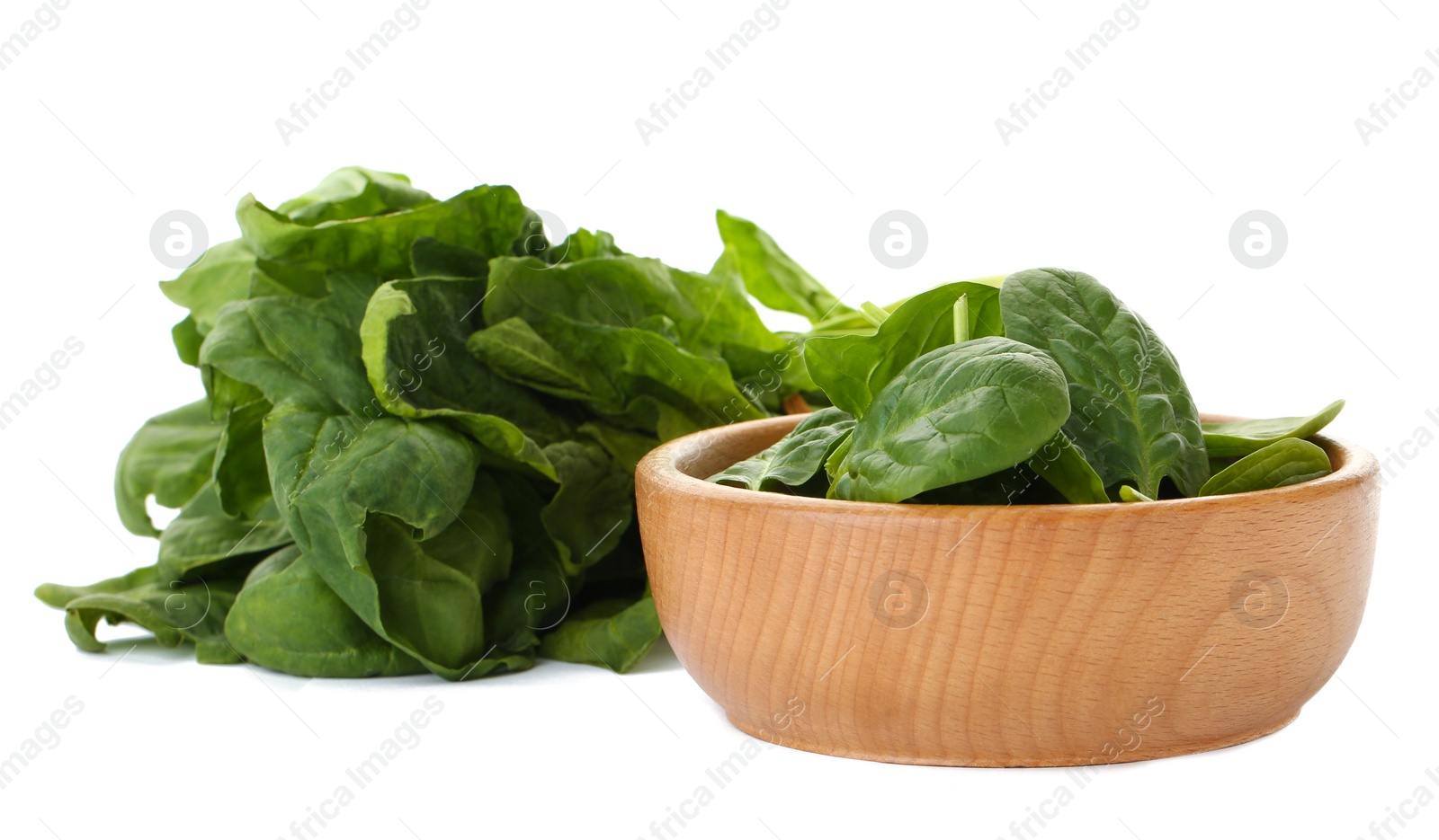 Photo of Bowl and spinach leaves isolated on white