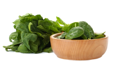 Photo of Bowl and spinach leaves isolated on white