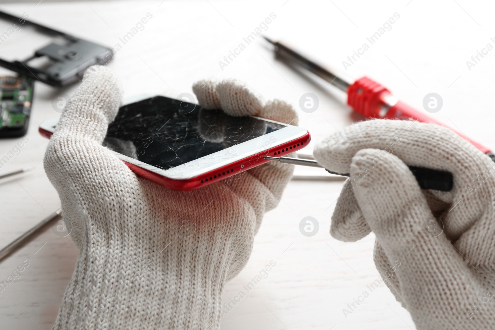 Photo of Technician fixing mobile phone at table, closeup. Device repair service