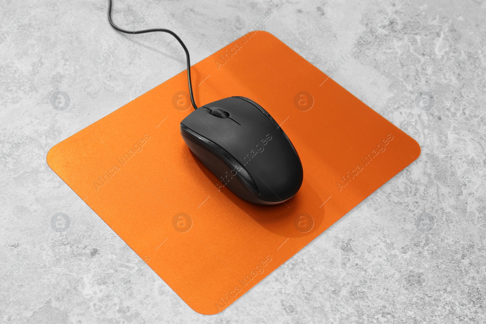 Photo of Blank pad and modern computer mouse on table