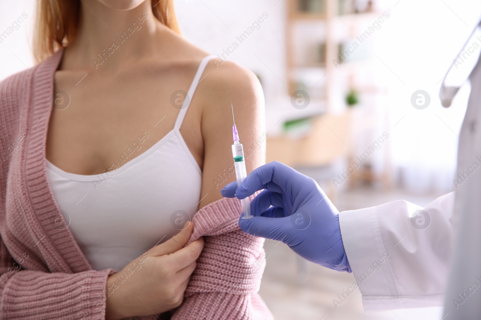 Photo of Doctor giving injection to patient in hospital, closeup. Vaccination concept