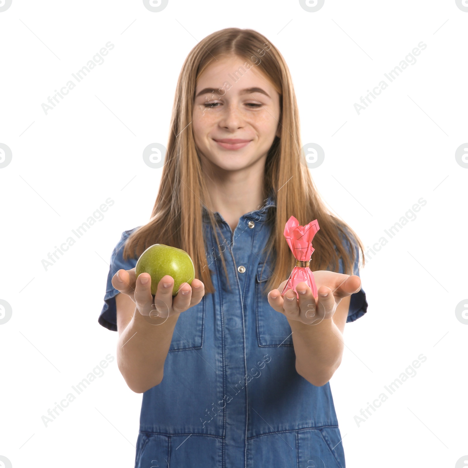 Photo of Teen girl with apple and candy on white background. Diabetes diet