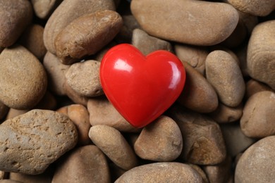 Photo of Red decorative heart on stones, above view