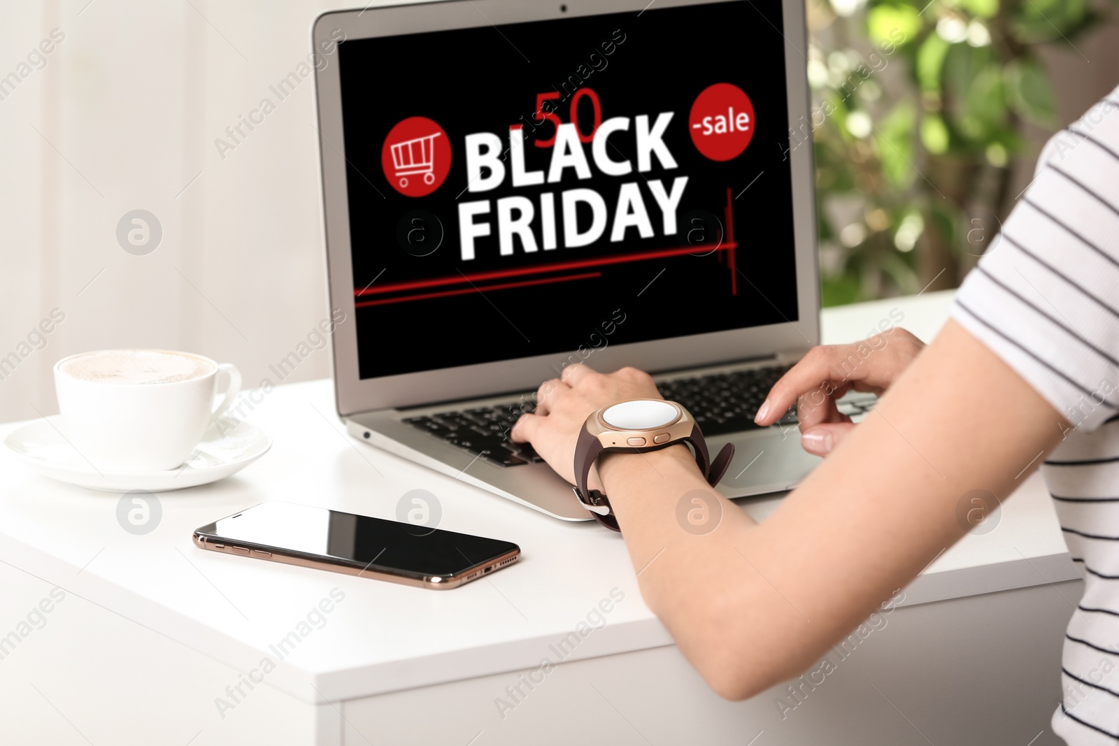 Image of Black Friday. Woman shopping online using laptop at table, closeup