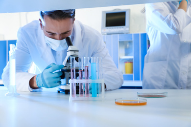 Photo of Scientist working with microscope indoors. Laboratory analysis