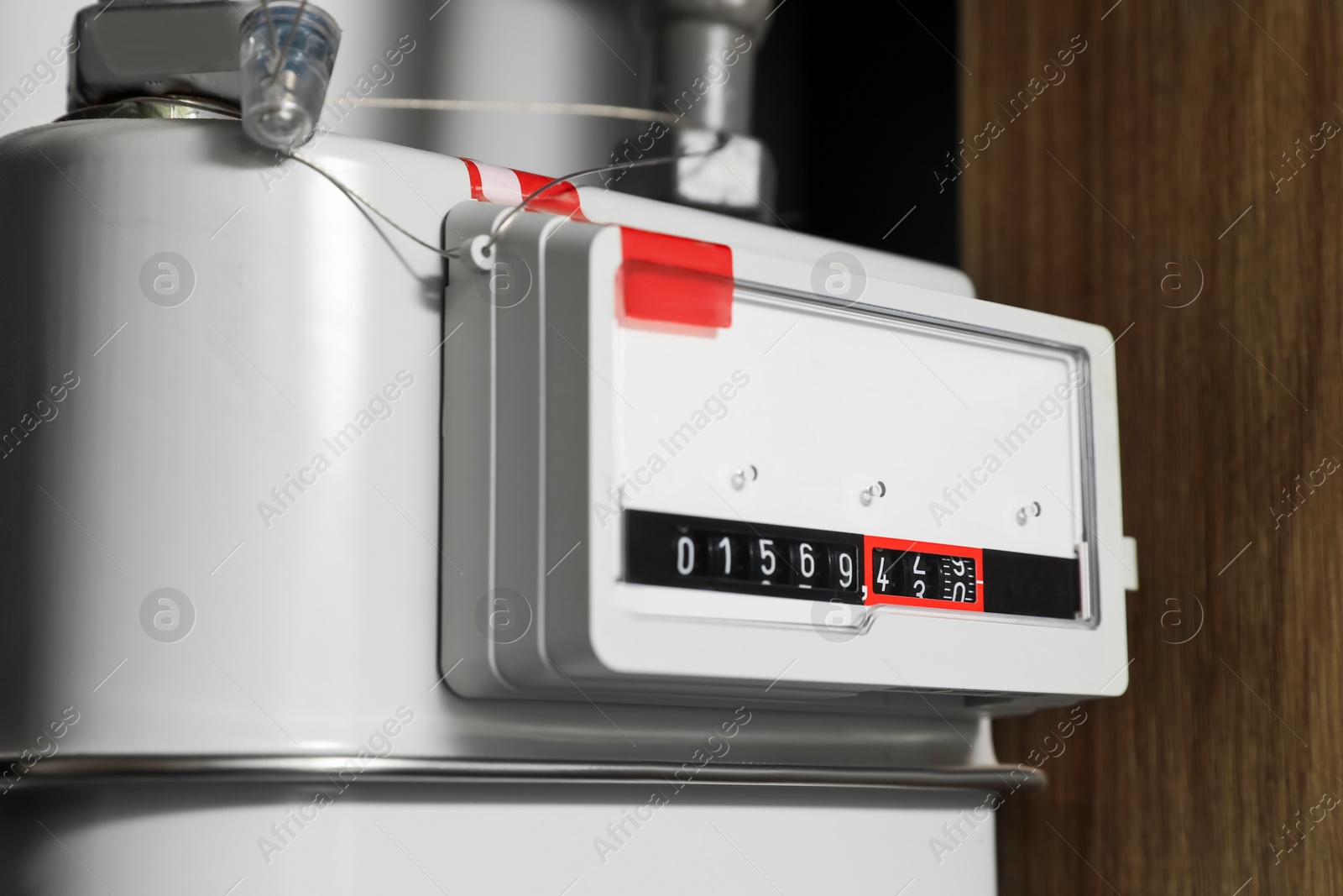 Photo of Electric meter near white wall, closeup. Gas measuring device
