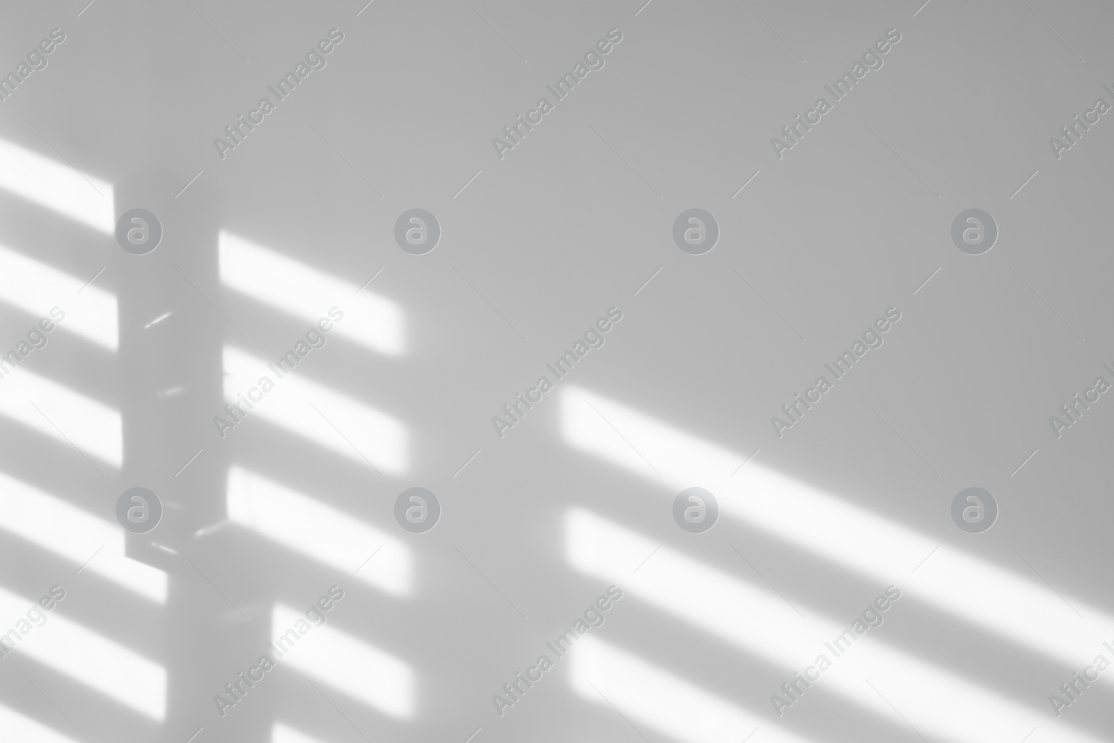 Image of Light and shadows falling on white wall