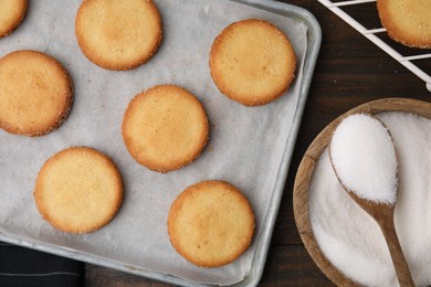 Photo of Tasty sweet sugar cookies on wooden table, flat lay