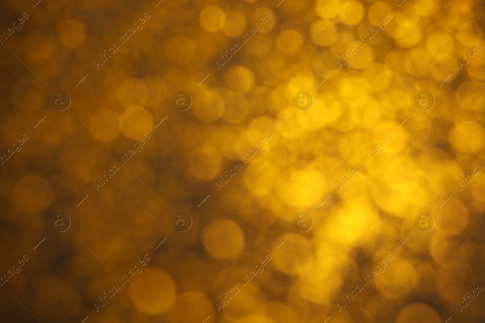 Photo of Blurred view of golden lights as background. Bokeh effect