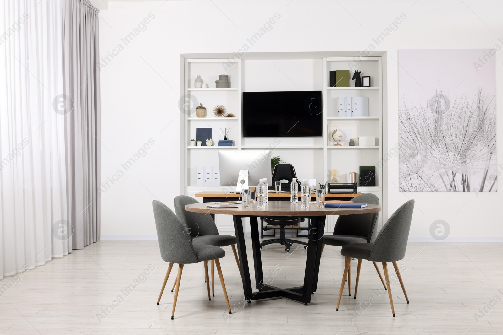 Photo of Stylish office with comfortable furniture and tv zone. Interior design