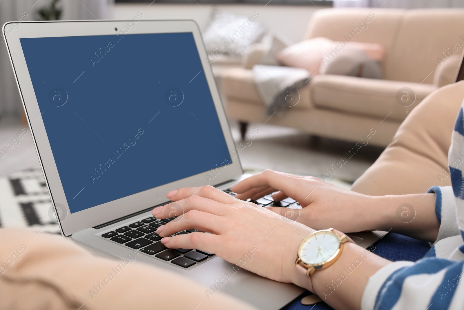 Photo of Young woman working with laptop in home office, closeup