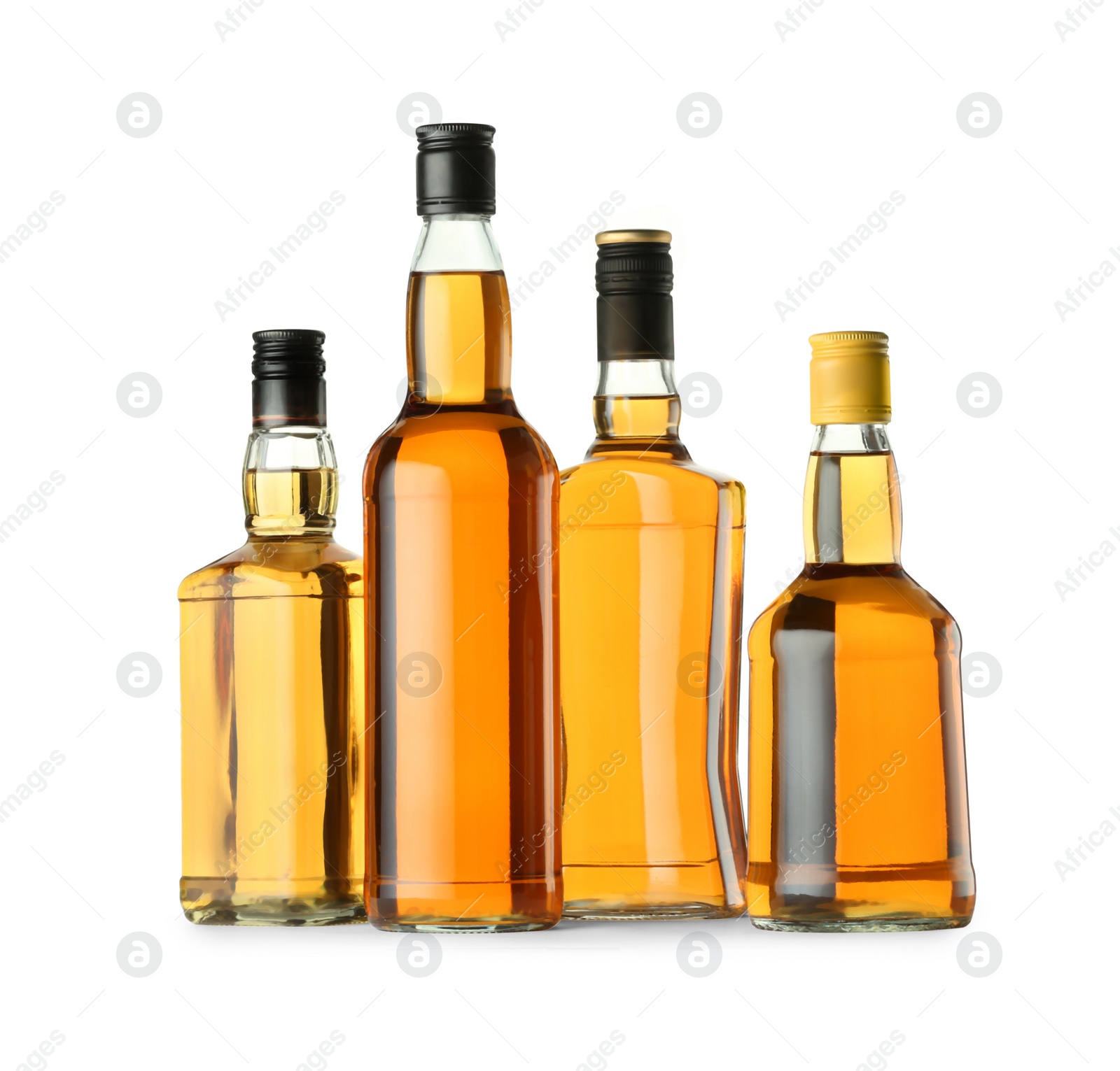 Photo of Different sorts of whiskey in glass bottles isolated on white