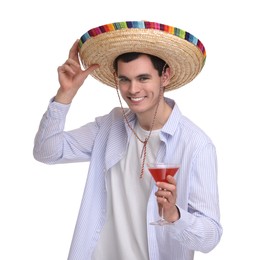 Young man in Mexican sombrero hat with cocktail on white background