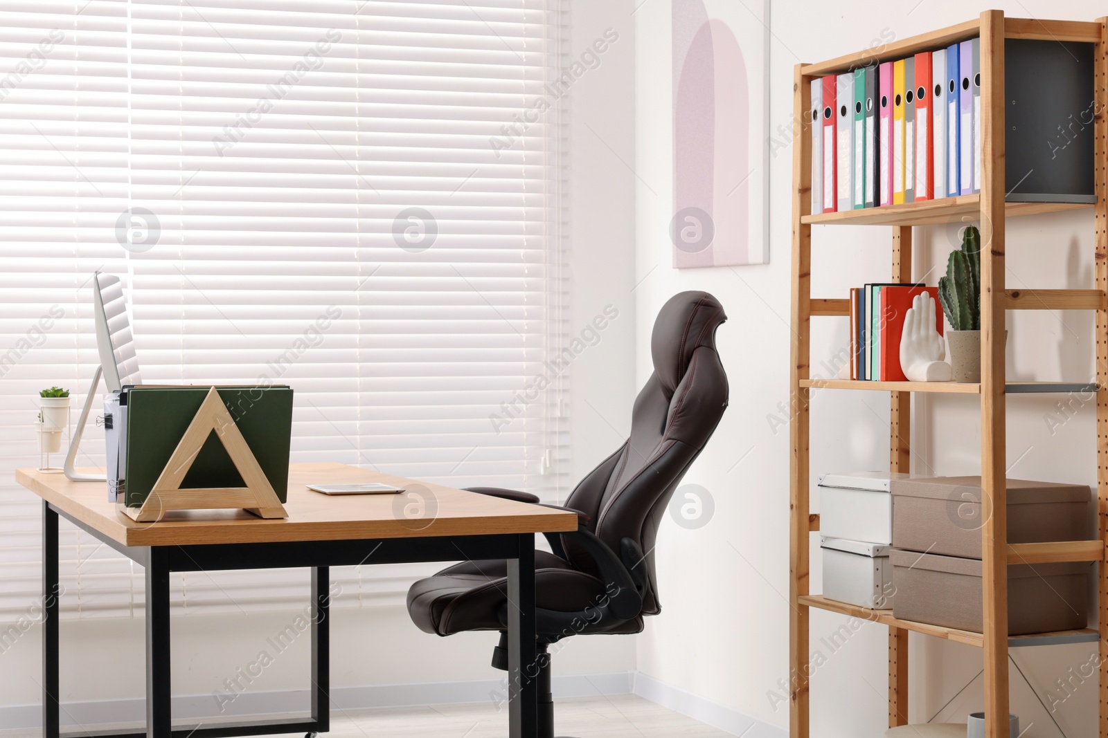 Photo of Desk and comfortable chair in modern office. Interior design