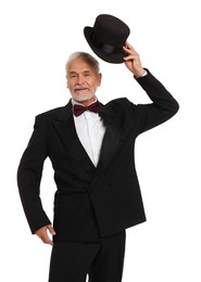 Handsome senior man in suit holding hat on white background