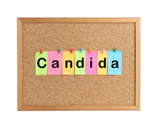 Cork board with word Candida made of colorful notes on white background
