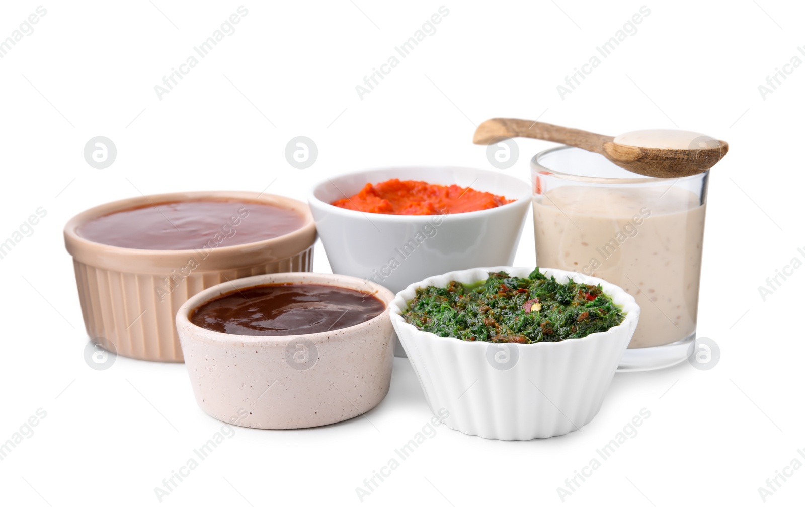 Photo of Different marinades in tableware isolated on white