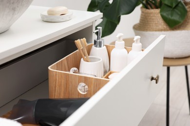 Photo of Different bath accessories and personal care products in drawer indoors