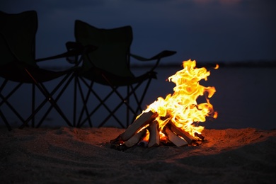 Beautiful bonfire with burning firewood on beach