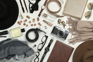 Photo of Fashionable male and female accessories on white wooden background, flat lay