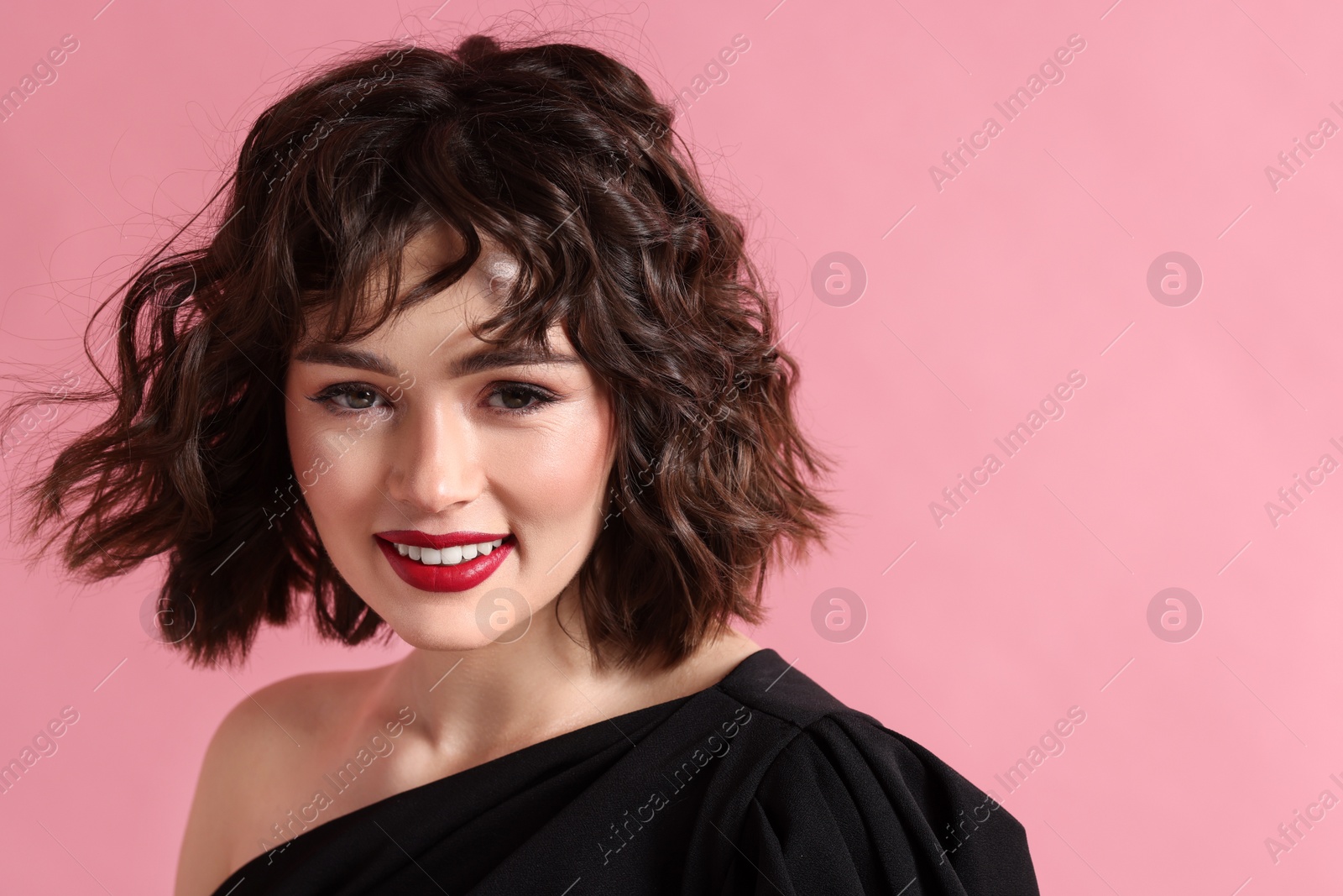 Photo of Portrait of beautiful young woman with wavy hairstyle on pink background. Space for text