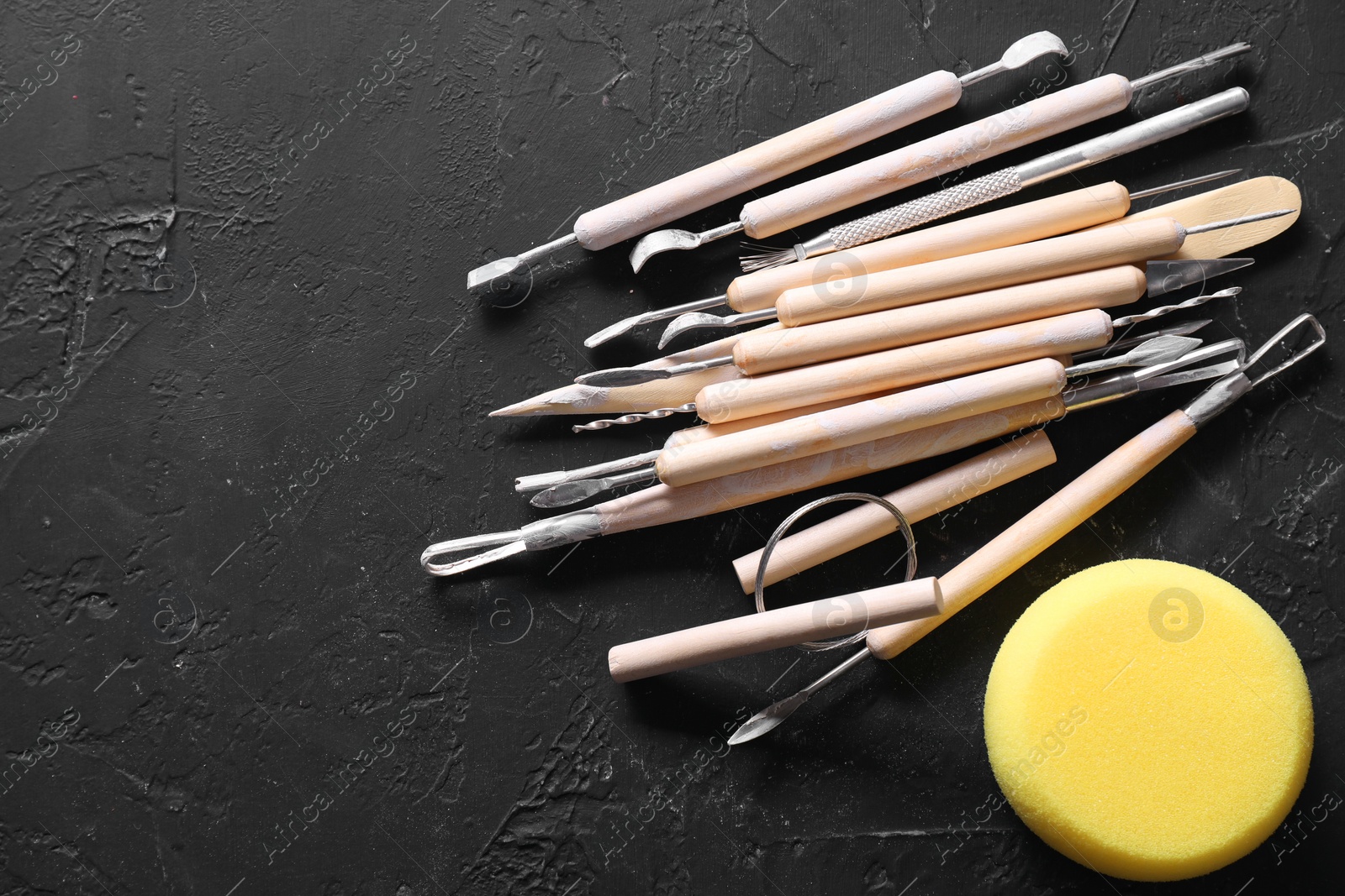 Photo of Set of different clay crafting tools and pottery sponge