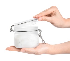 Woman holding jar of salt scrub on white background, closeup