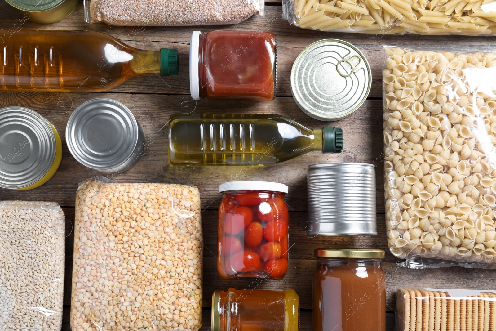 Photo of Different products on wooden table, flat lay. Food donation