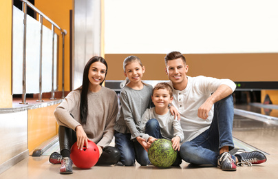 Photo of Happy family spending time together in bowling club