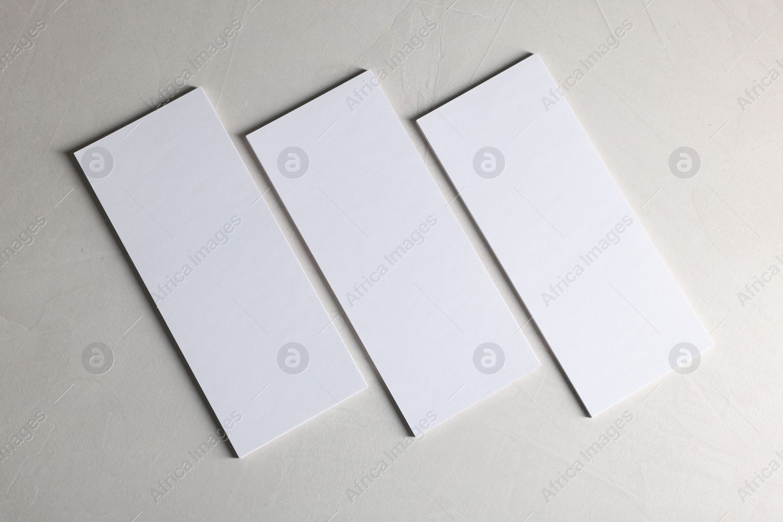 Photo of Blank business cards on light textured background, top view. Mockup for design