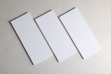 Blank business cards on light textured background, top view. Mockup for design