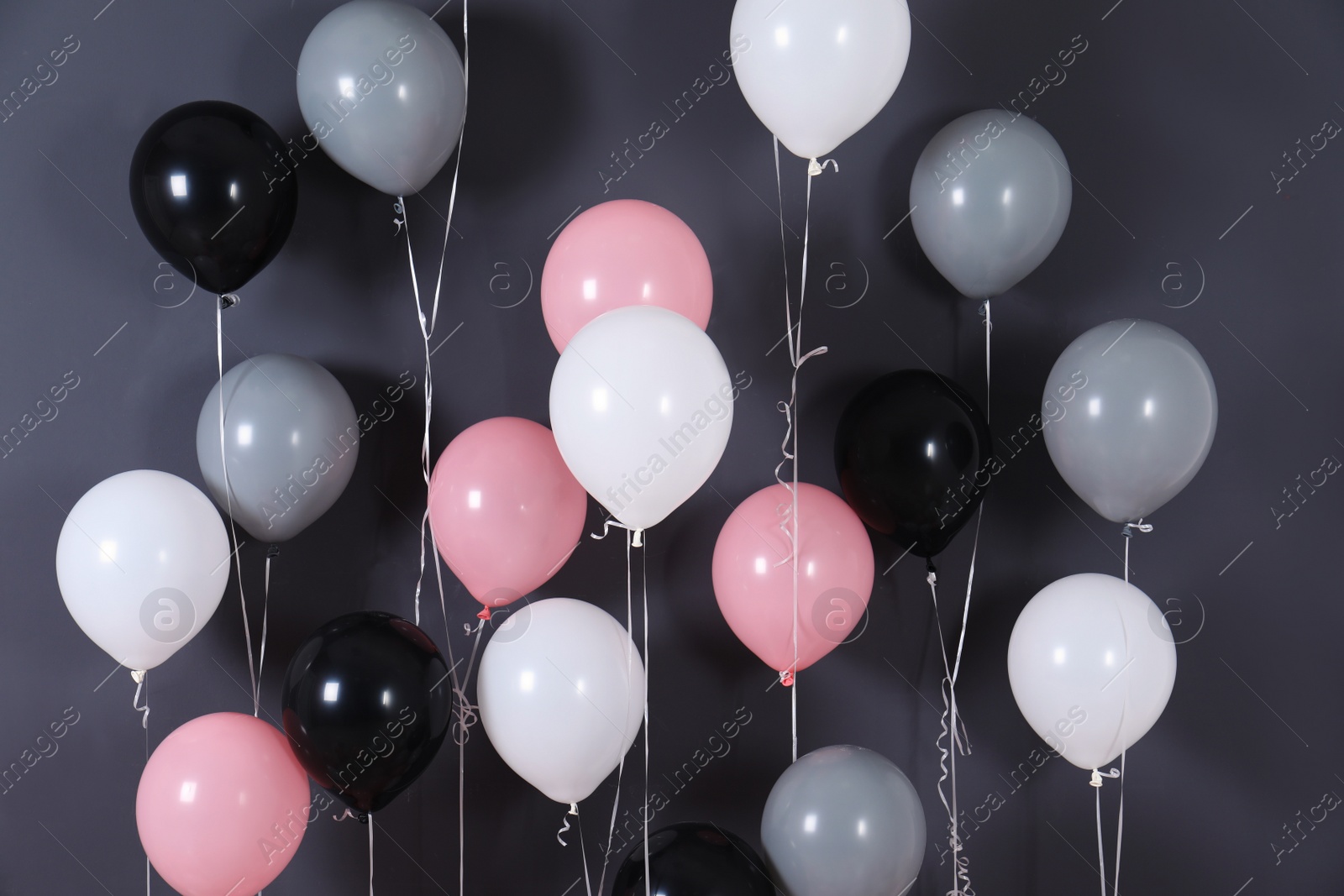 Photo of Bright balloons near color wall. Festive decoration