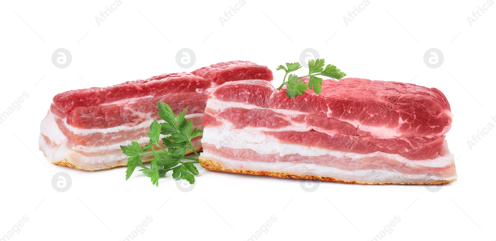 Photo of Pieces of raw pork belly and parsley isolated on white