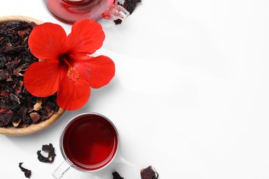 Delicious hibiscus tea and flowers on white background, flat lay. Space for text