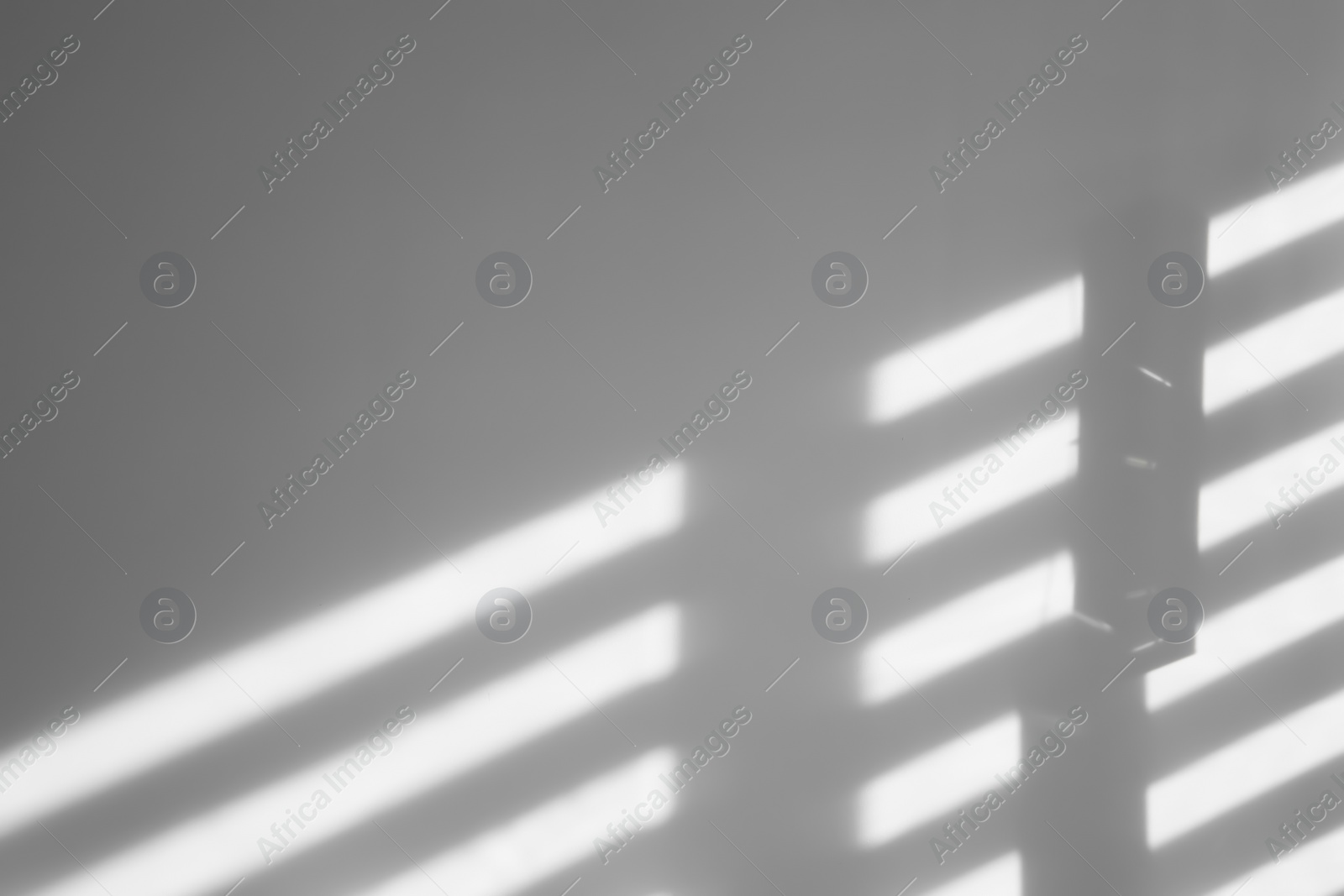 Photo of Lines made of light and shadows on white wall