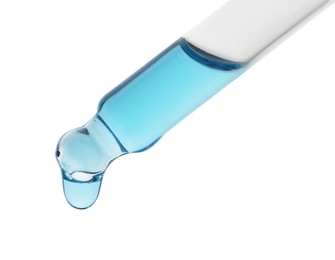 Photo of Dripping light blue facial serum from pipette on white background, closeup