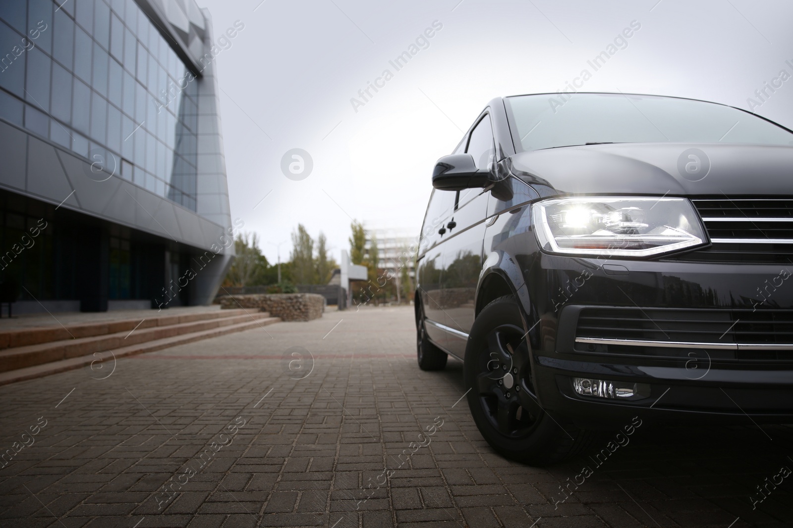 Photo of Black delivery van parked on street near building