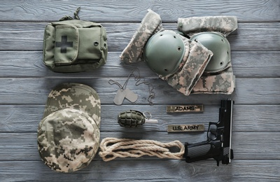 Photo of Set of military outfit on dark wooden background, flat lay