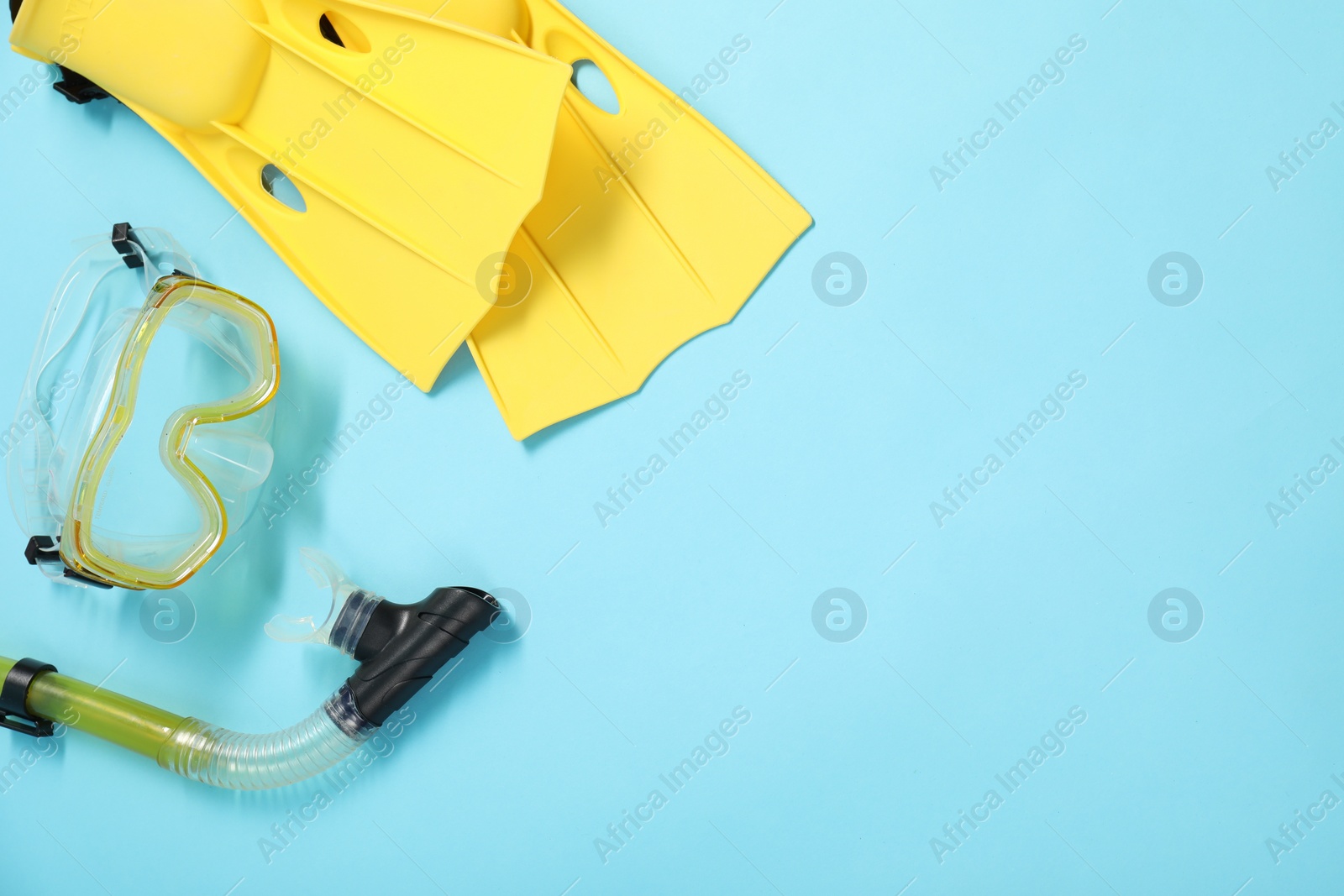 Photo of Different sports equipment on light blue background, flat lay. Space for text