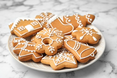 Photo of Plate with tasty homemade Christmas cookies on table