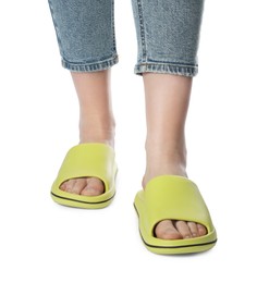 Woman in green slippers on white background, closeup