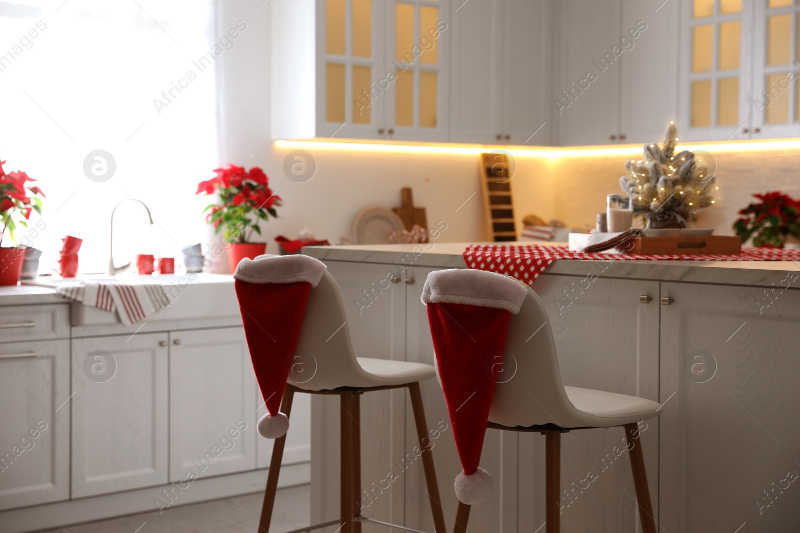 Photo of Stylish kitchen interior with beautiful Christmas decor