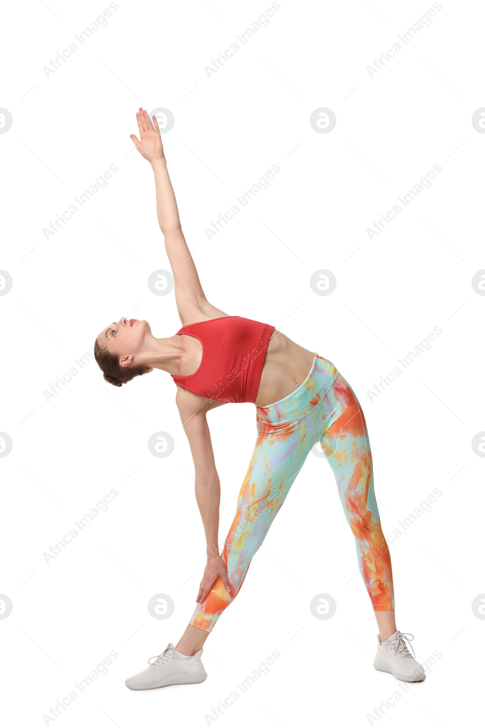 Photo of Yoga workout. Young woman stretching on white background